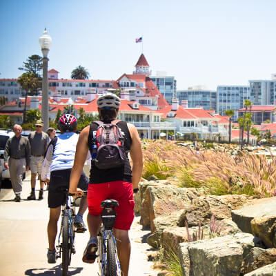 2 bikers riding along coronado near the hotel del