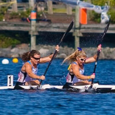 two people paddling a kayak competitively