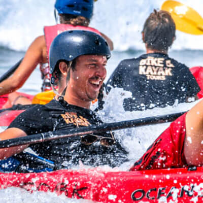 person laughing in a red kayak