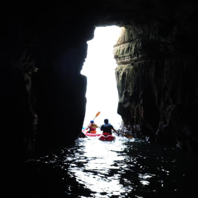 Kayakers paddling through the seven caves
